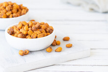 Roasted Salted Corn Nuts With Spice And Sauce In Bowl On White Table, Nut Concept