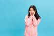 © SHOTPRIME STUDIO - Excited lovely Asian student young lady in pink hoodie sweatshirt recline on hands posing isolated on over blue studio background. The best offer for ad. People Emotions for Everyday concept