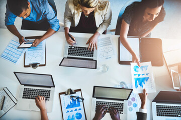 Aufkleber - Birds-eye view of business. High angle shot of a team of businesspeople working around a table in the office.