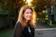 © Мар'ян Філь - Beautiful woman meets the sunset and enjoys life and health after 45 years. Portrait of a happy mature woman, the sun shines through her hair