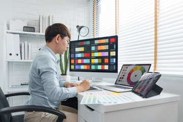 Wall Mural - creativity concept, male graphic designer using tablet and looking color swatch samples on screen