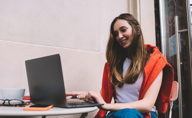 Creative female freelancer working on project with laptop computer. Hipster girl learning online with webinar course for to improve skills. Modern device and internet connection in our lives