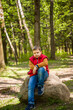 © Alina Lebed - Portrait of a young man in a red tank top in the forest in spring. Walk through the green park in the fresh air. The magical light from the sun's rays falls behind the boy.
