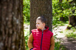 © Alina Lebed - Portrait of a boy in the forest in spring. Take a walk in the green park in the fresh air. The magical light from the sun's rays is left behind. Space for copying. Selective focus.