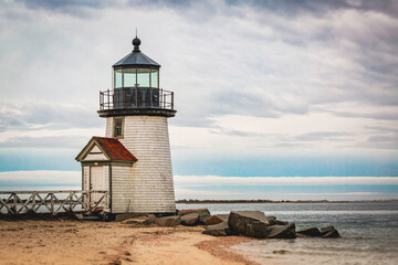 Dramatic seascape and cloudscape at dusk over Brant Point Light Lighthouse on the Tip of Sand Bar on Nantucket Island