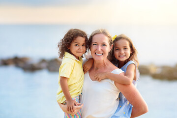 Mother and kids on tropical beach.