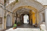 Fototapeta Na drzwi - A narrow street between the old houses of Galatina, an old village in the province of Lecce in Italy.