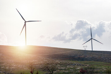 view of wind turbines at sunset. wind power or wind energy is mostly the use of wind turbines to gen