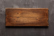 Wooden nameplate or sign board screwed at wall background. Front view of name plate