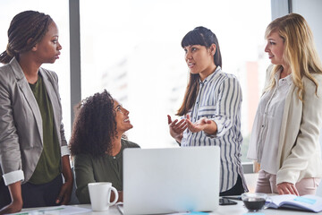 Wall Mural - Giving your opinion is the right step to take in business. Cropped shot of a group of businesswomen having a meeting in the office.