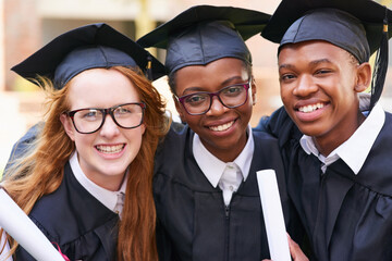 Graduation day is all about us. Portrait of a happy group of students standing outside on their graduation day.