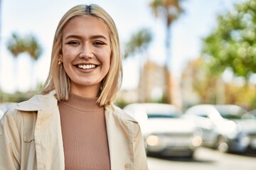 Poster - Young blonde girl smiling happy standing at the city.