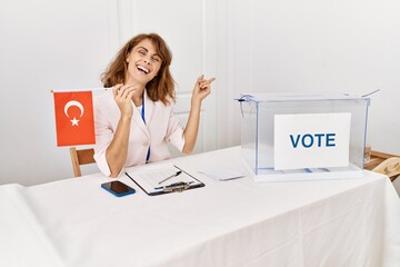 Sticker - Beautiful caucasian woman at political campaign election holding tunisia flag smiling happy pointing with hand and finger to the side