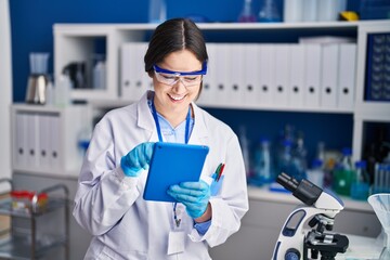 Poster - Young woman scientist using touchpad at laboratory