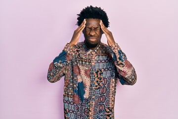 Poster - Young african american man wearing casual clothes suffering from headache desperate and stressed because pain and migraine. hands on head.