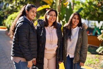 Three woman mother and daughters standing together at park