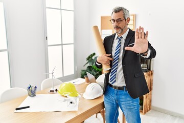 Sticker - Middle age hispanic business man holding paper blueprints doing stop gesture with hands palms, angry and frustration expression