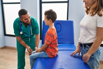 Sticker - Family having medical consultation doing reflex knee test at clinic