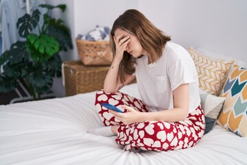 Sticker - Young woman using smartphone sitting on sofa at bedroom