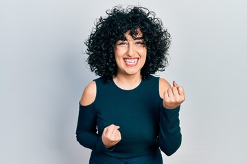 Poster - Young middle east woman wearing casual clothes celebrating surprised and amazed for success with arms raised and eyes closed