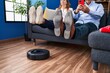 © Krakenimages.com - Middle age man and woman couple cleaning floor using robot cleaner at home