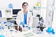 © Krakenimages.com - Young hispanic woman wearing scientist uniform working at laboratory