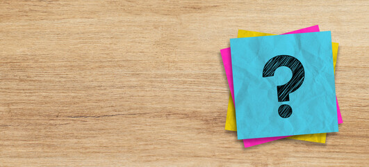 Wall Mural - crumpled note paper with question mark on textured wood background