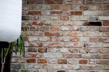 brick wall with graffiti with window and red brick