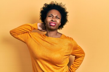 Wall Mural - Young african american woman wearing casual clothes suffering of neck ache injury, touching neck with hand, muscular pain