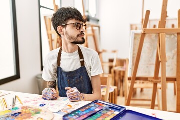 Poster - Hispanic man with beard at art studio looking to side, relax profile pose with natural face with confident smile.