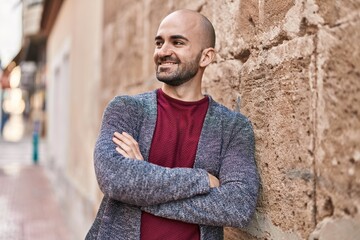 Poster - Young man smiling confident standing with arms crossed gesture at street