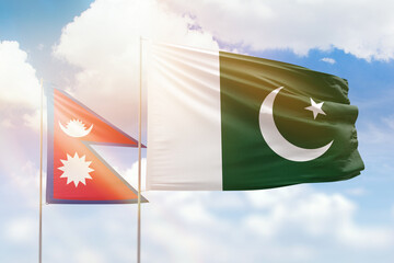 Sunny blue sky and flags of pakistan and nepal