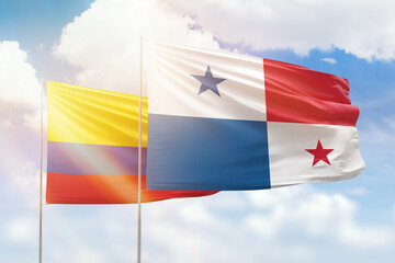 Wall Mural - Sunny blue sky and flags of panama and colombia