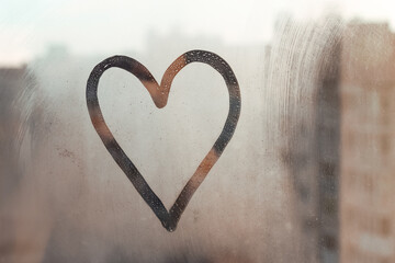 Doodle heart painted on glass wet blu window at home