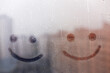 © ksenija1803z - Foggy glass on window with two drawn smile face concept positive photo