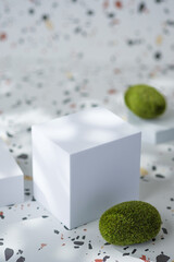 Leinwandbilder - White geometric pedestal on terrazzo background with summer sunlight and green moss rock