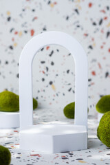 Poster - White geometric pedestal on terrazzo background with summer sunlight and green moss rock
