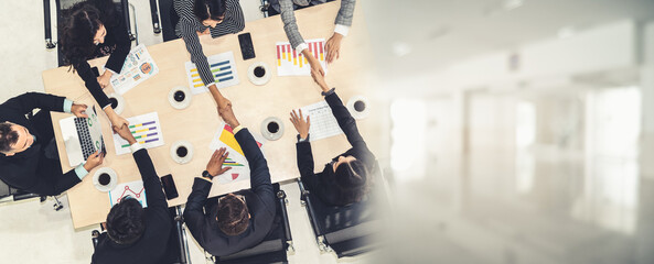 Wall Mural - Group business people handshake at meeting table in office together with confident shot from top view . Young businessman and businesswoman workers express agreement of investment deal. broaden view