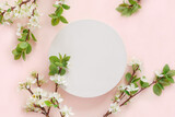 Fototapeta Kawa jest smaczna - Round Podium with flowering apple branches for product presentation. Abstract minimal geometrical form on pink background. One Showcase, white flowers, soft shadow. Scene, display. Top view, Flat lay