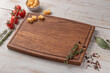 © Alexander - square wooden cutting board with edging. cherry tomatoes, slices of cheese and spices on a white background. mockup with copy space for text, side view