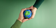 World Earth Day Concept. Green Energy, ESG, Renewable And Sustainable Resources. Environmental Care. Hands Of People  Embracing A Handmade Globe. Protecting Planet Together. Top View