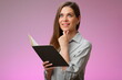 © Yuriy Shevtsov - Happy teacher or student woman holding open book and looking up, isolated portrait.