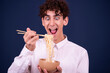 Funny guy eating chinese noodles
