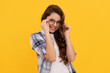 cheerful teen child in checkered shirt and glasses on yellow background
