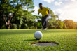 © somchai - Golfer putting ball on the green golf, lens flare on sun set evening time.