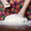 Female hands making dough. Dough kneading process. Dough based on natural sourdough. Wheat dough. Fermentation.	