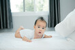 © saranyoo - Cute little asian baby on bed with soft blanket indoors