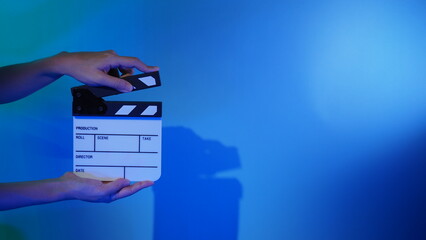 Movie Clapper board. Crew hand holding plastic and wooden film slate board against camera. Movie clapperboard using in video production and movie studio works film industry. Film slate on crew hand.