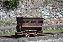 Old Rusty Mining Cart On Train Tracks