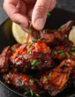 Baked chicken wings with sweet chili, honey sauce in black bowl